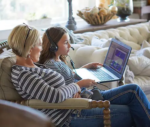 mom with daughter using the computer