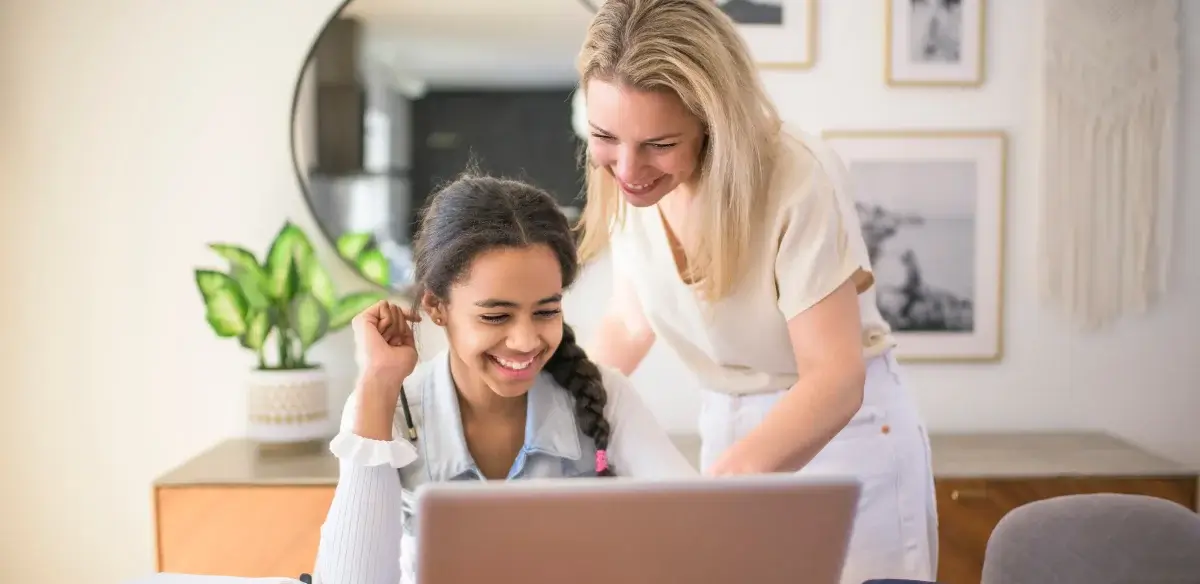 Mother and daughter working together with their laptop