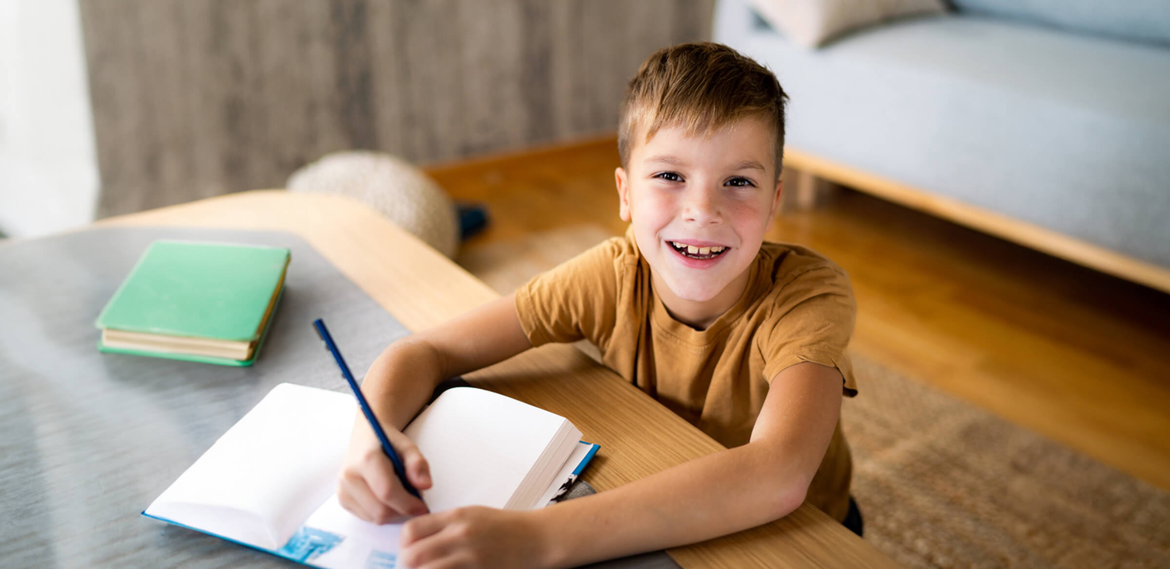 Elementary student taking notes at home